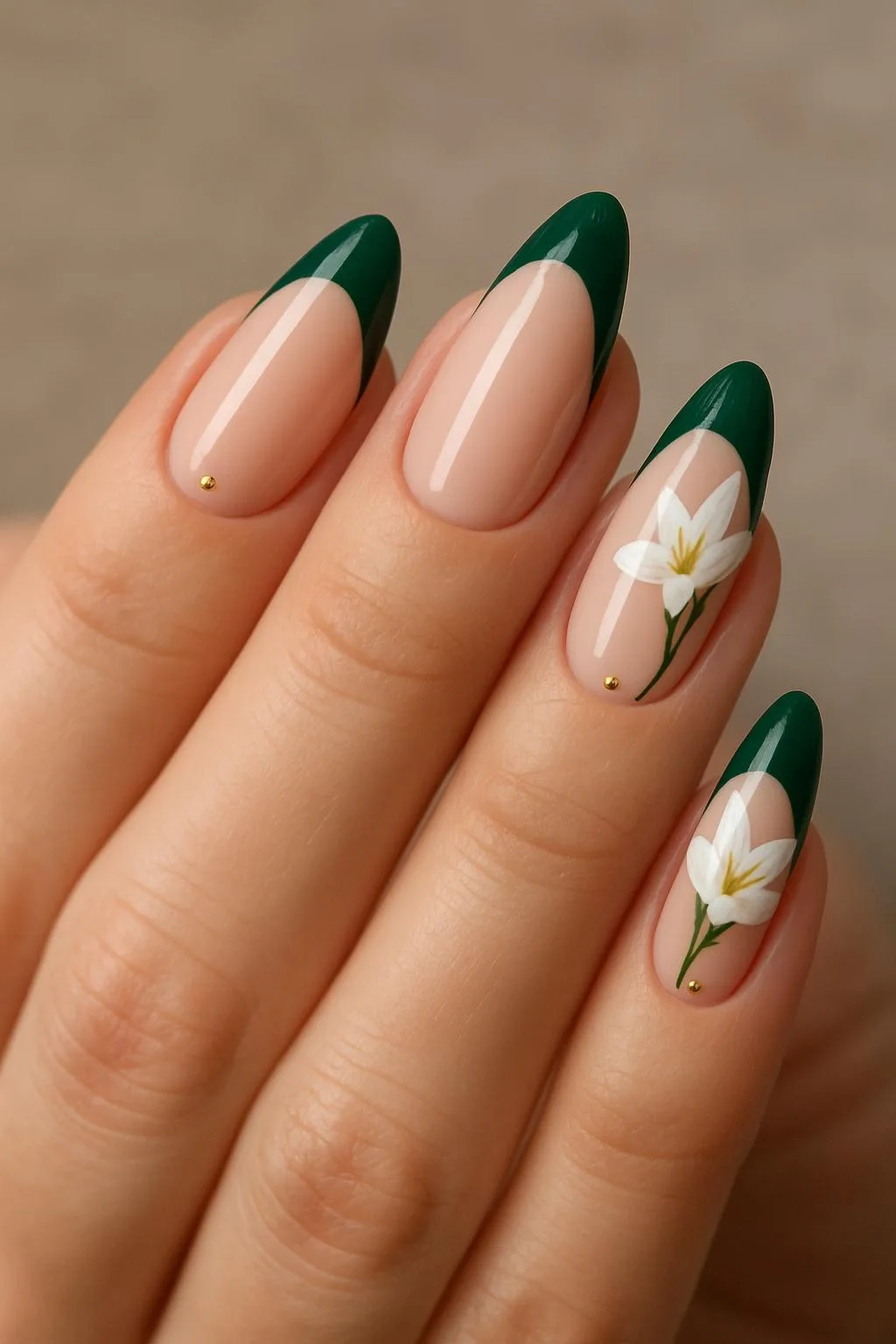 Almond nails with deep green French tips and white floral art
