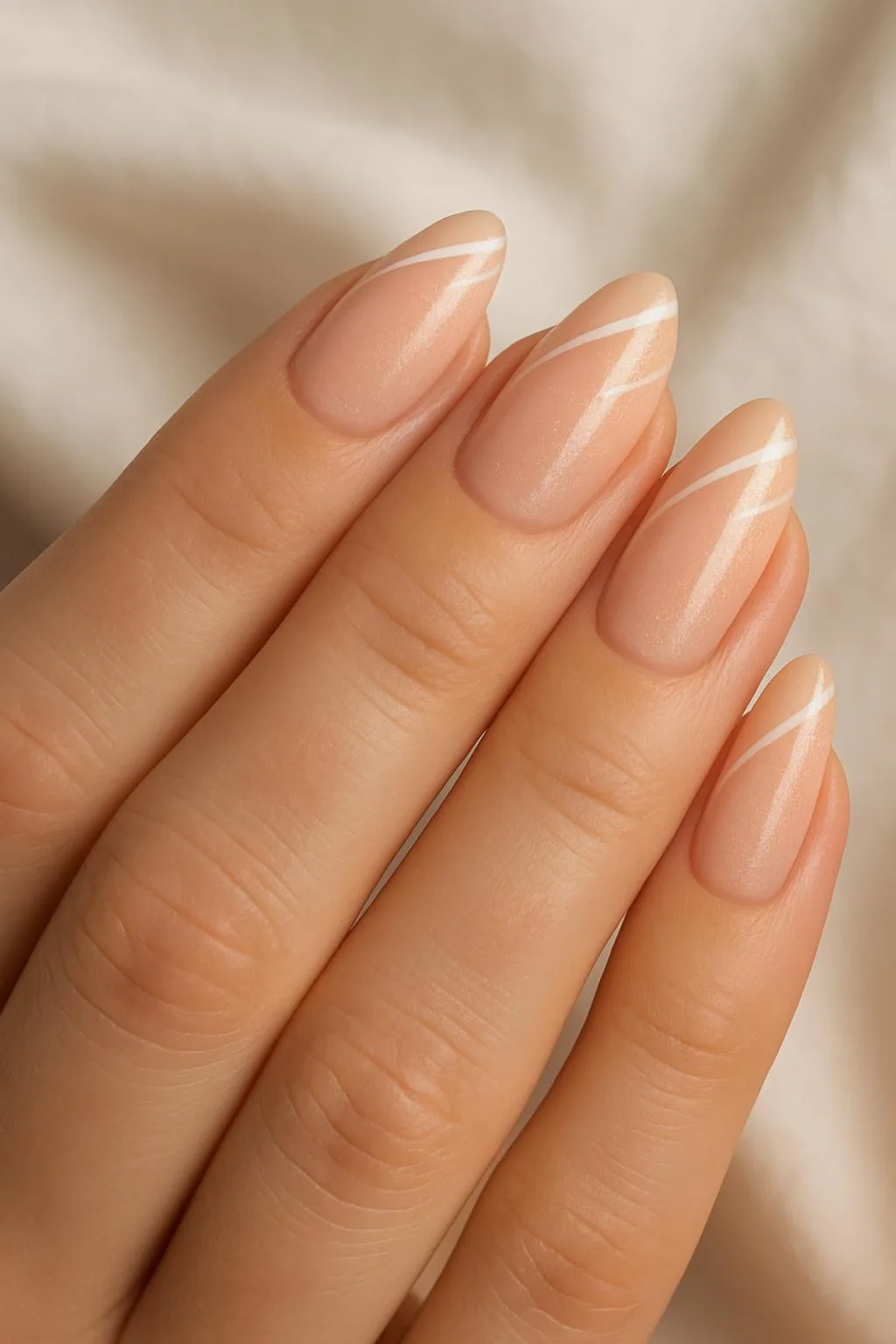 Almond-shaped nude nails with diagonal white minimalist lines