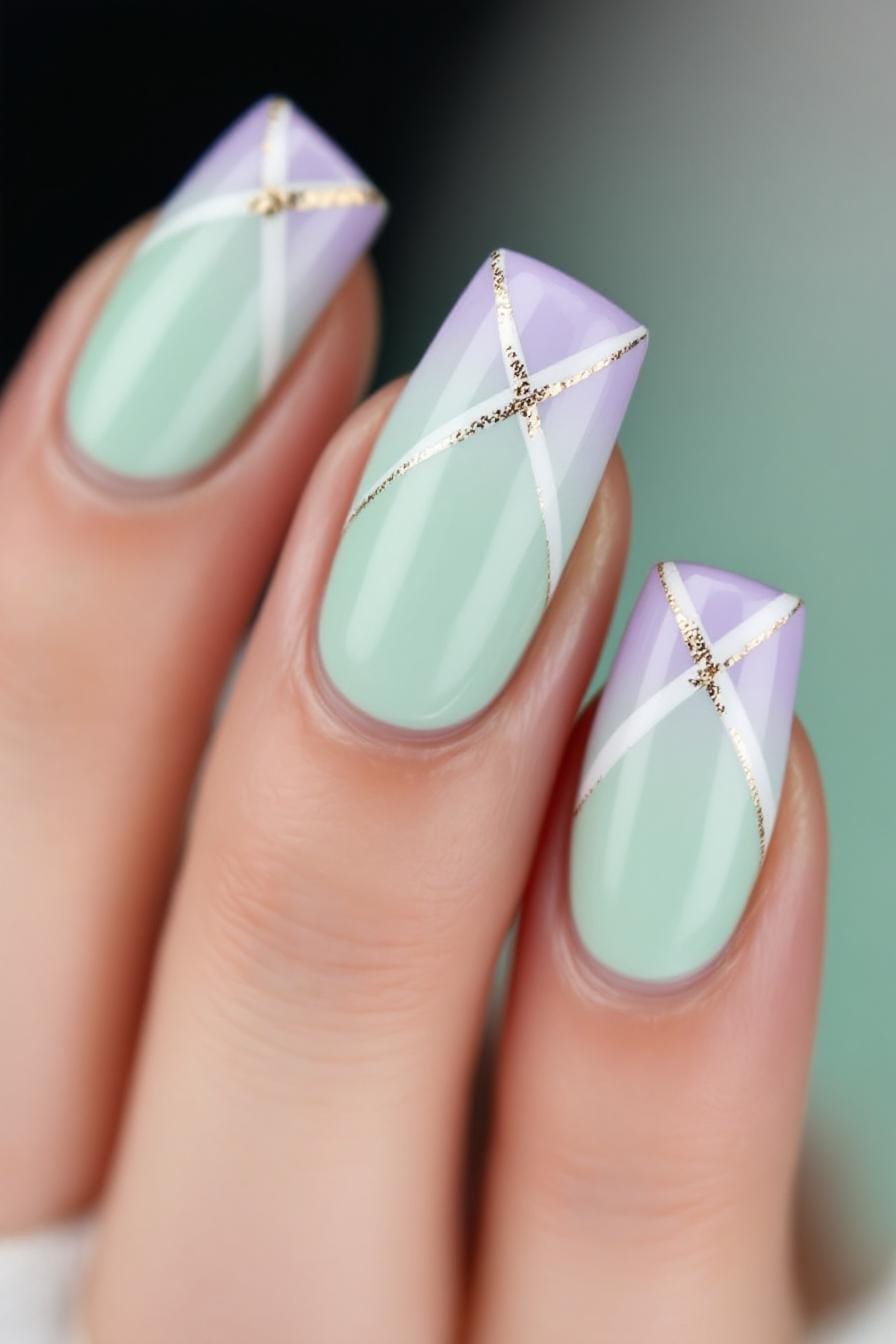 Pastel green and lilac nails with metallic gold and white criss-cross stripes