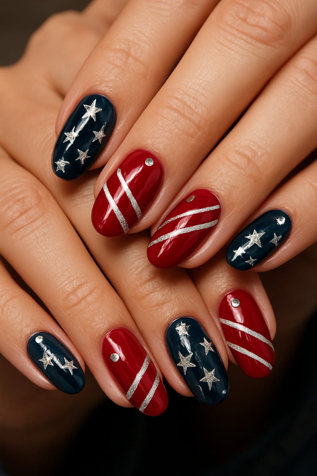Red and navy nails with silver stars and stripes