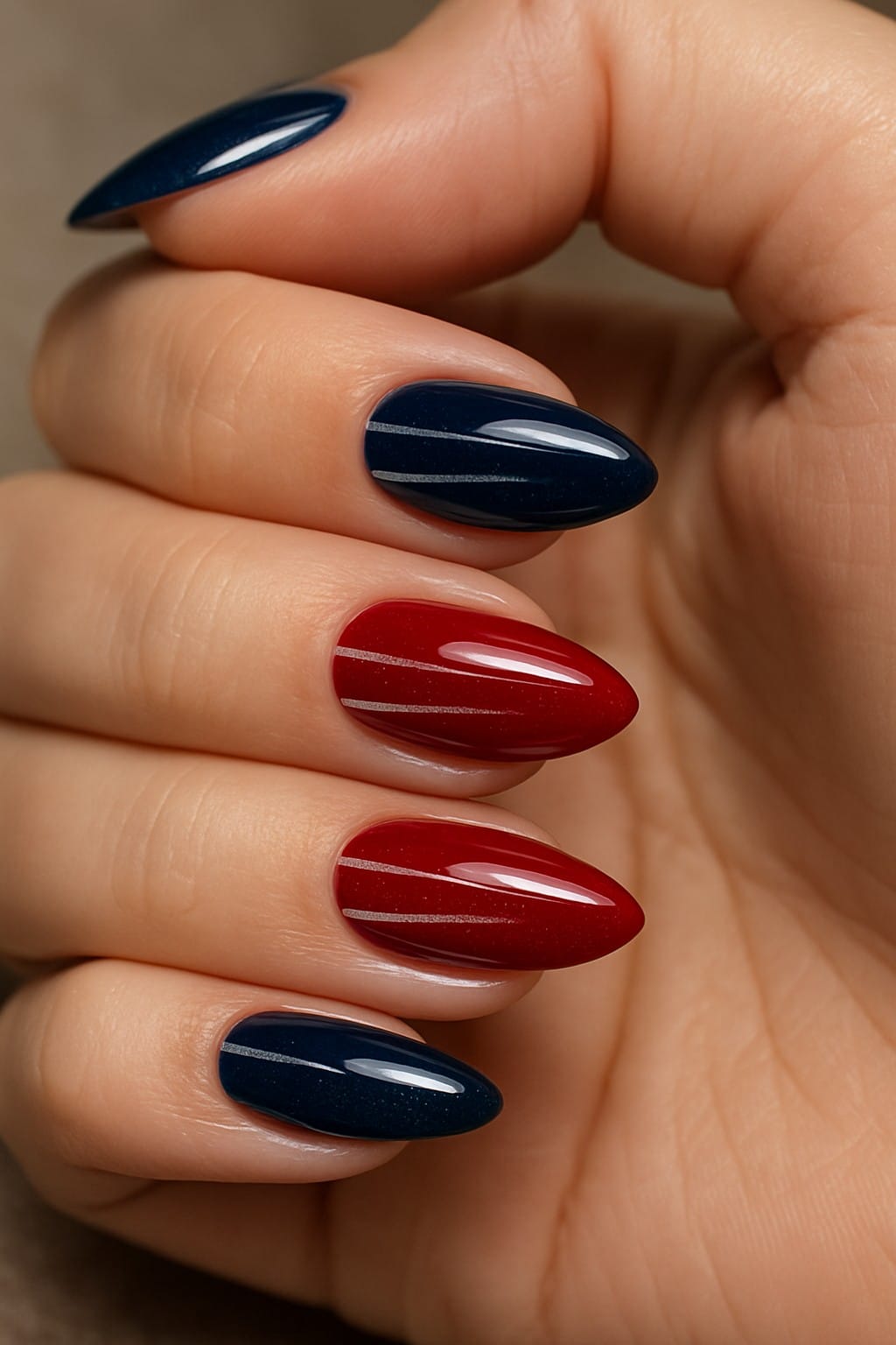 Red and navy nails accented with thin silver stripes