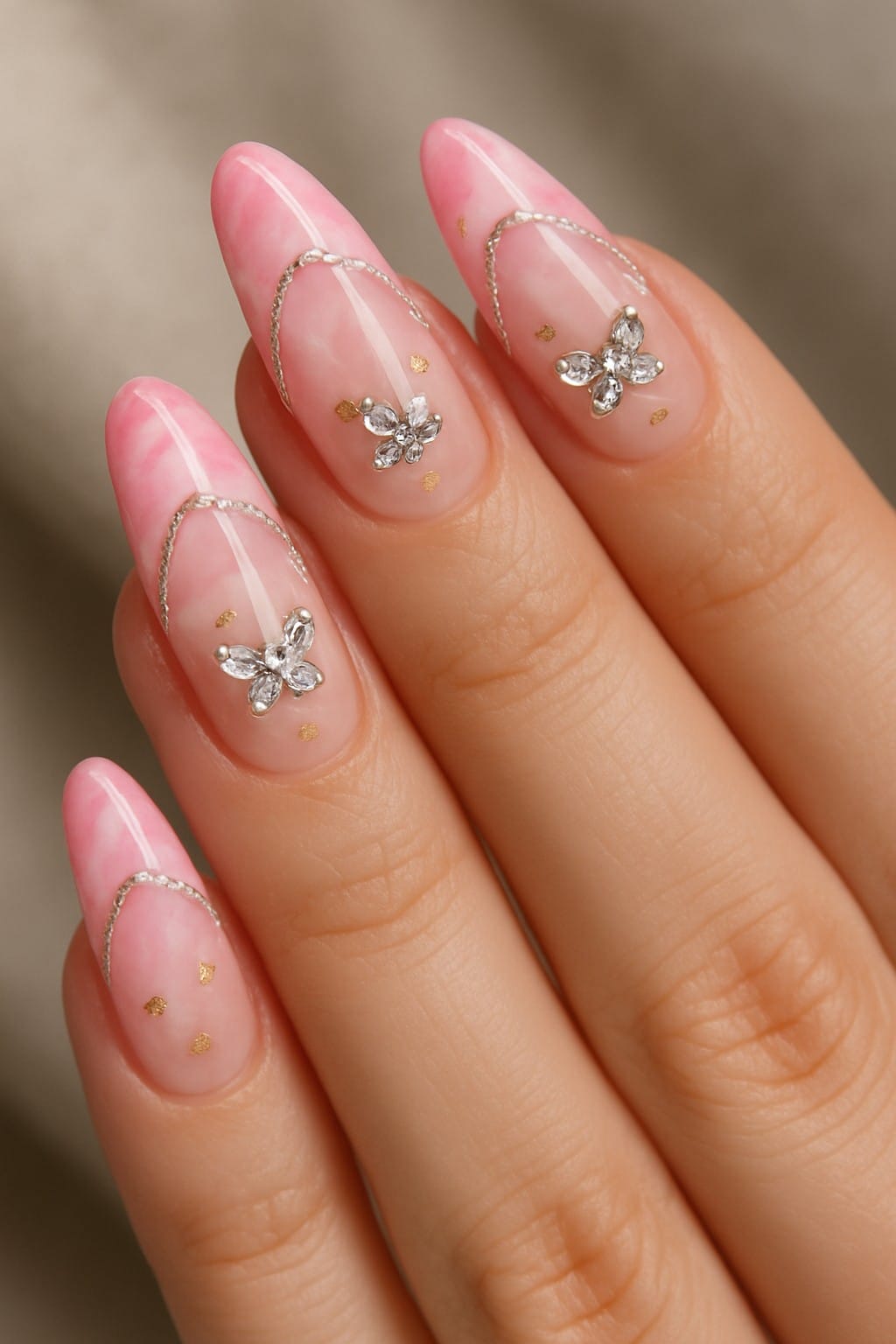 Pink French tips with crystal butterfly charms and silver chain details