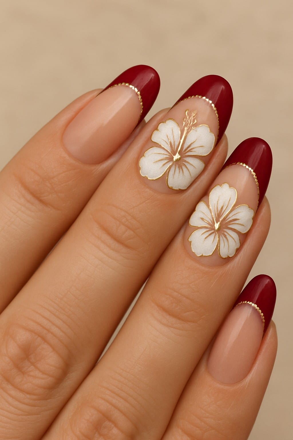 Nude nails with white hibiscus flowers and deep red French tips