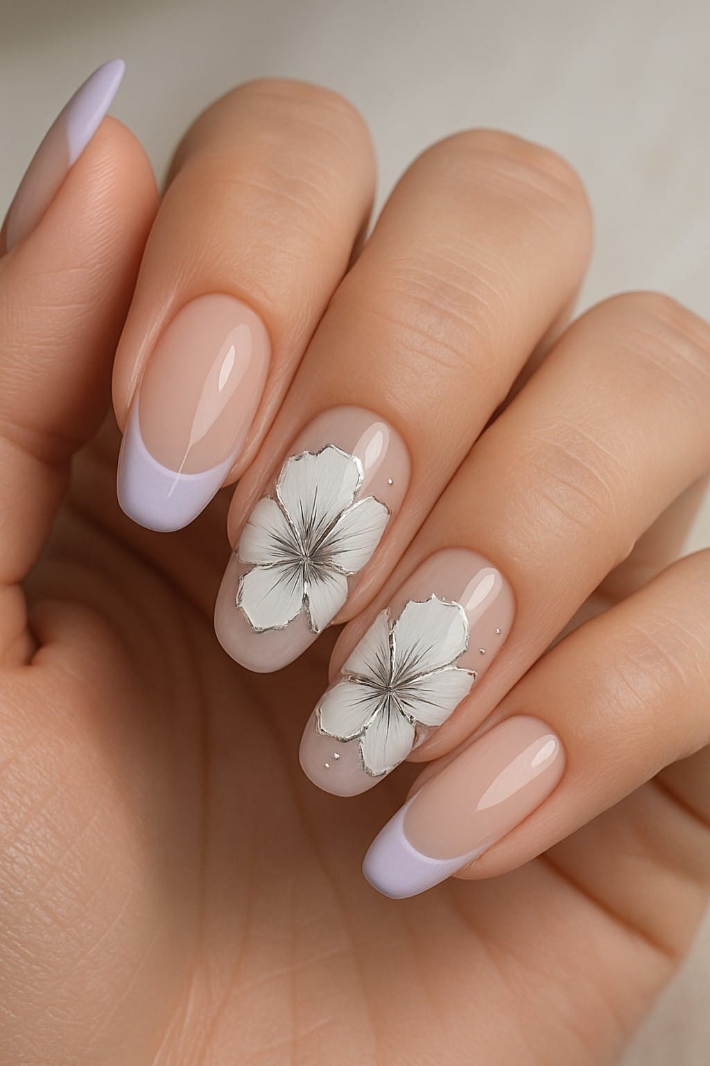 Soft pastel French tips with white hibiscus floral nail art