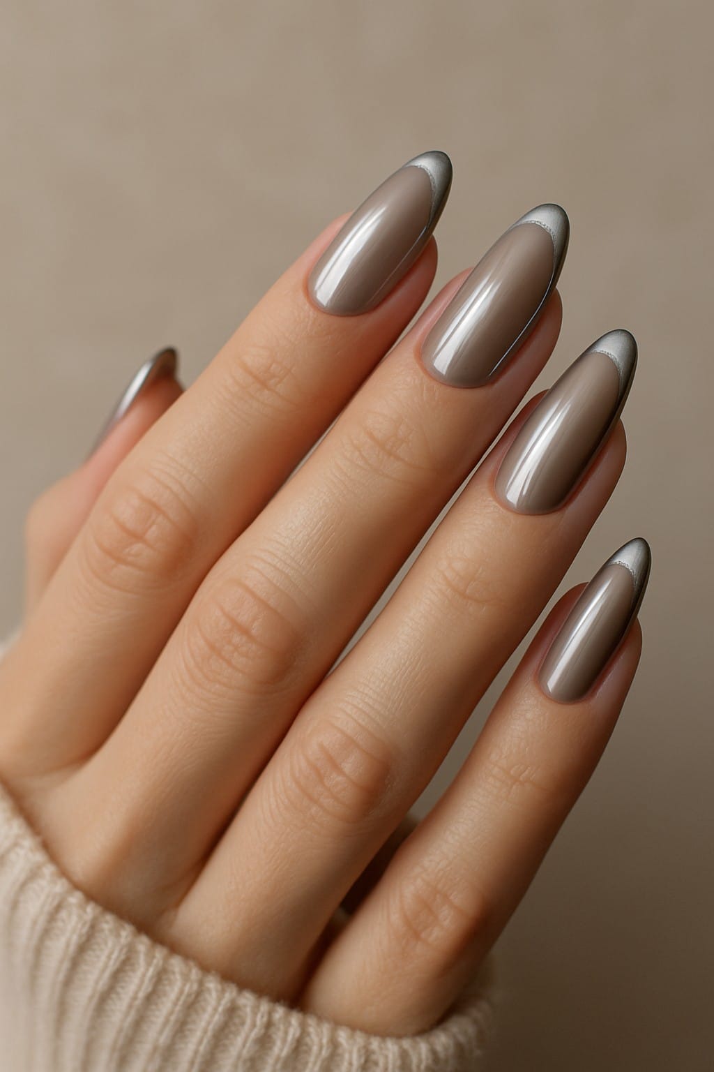 Taupe almond-shaped nails with chrome silver tips
